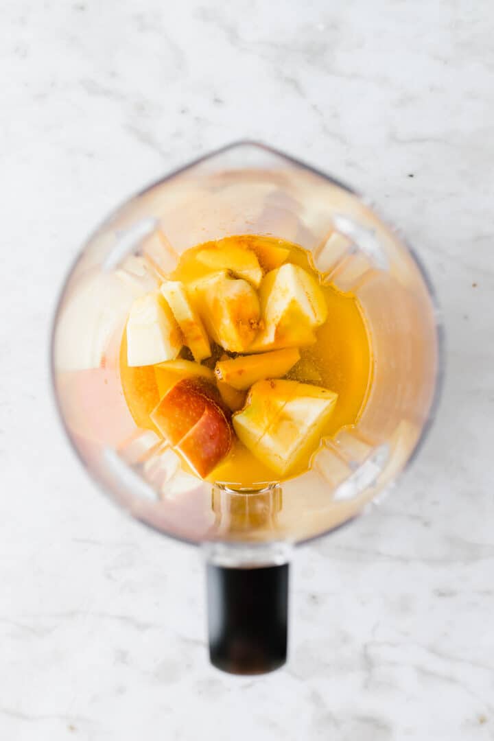 apples, ginger, lemon juice, and turmeric in a blender