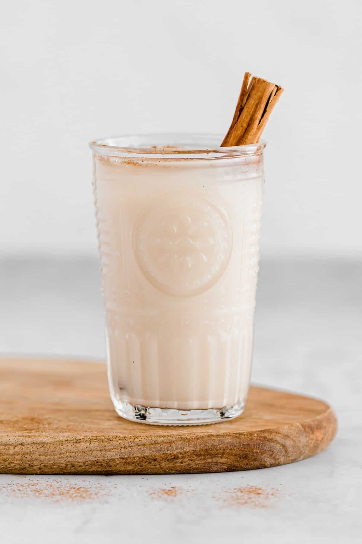 a glass with homemade horchata and a cinnamon stick