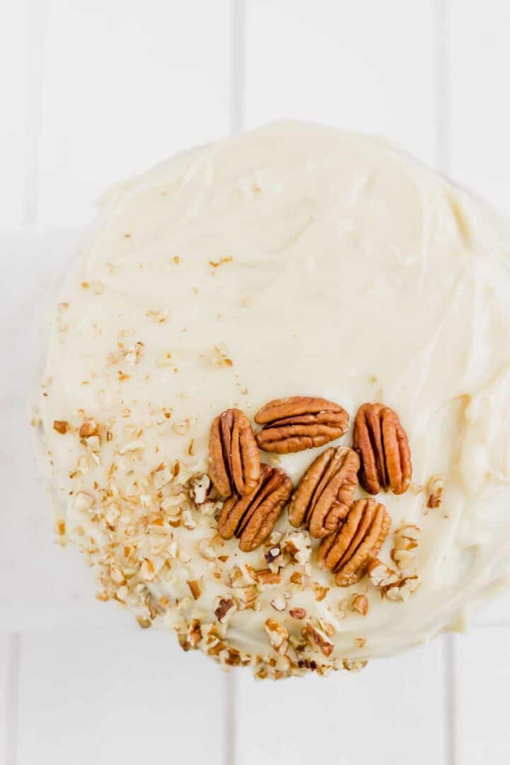 carrot cake with frosting and pecan nuts