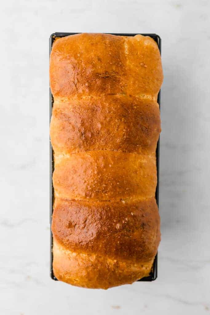 baked french brioche bread in a loaf pan