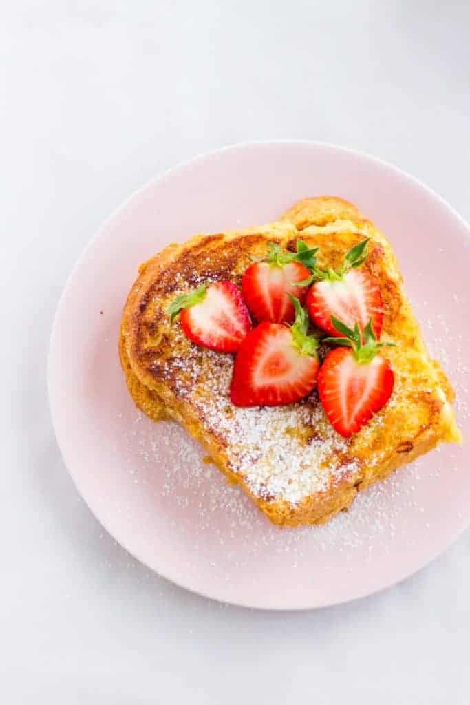 Brioche French Toast with strawberries and powdered sugar