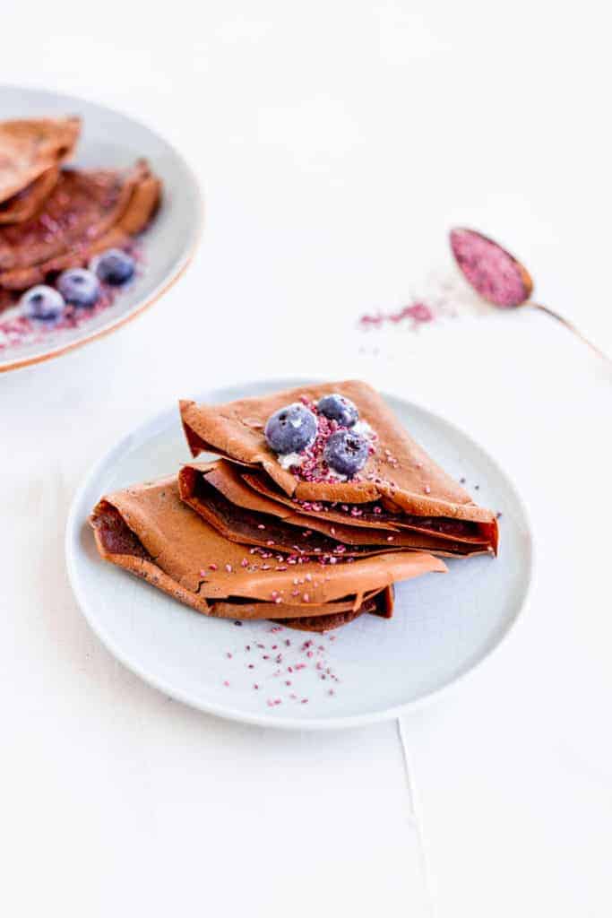 crepes made with cacao powder served on a blue plate