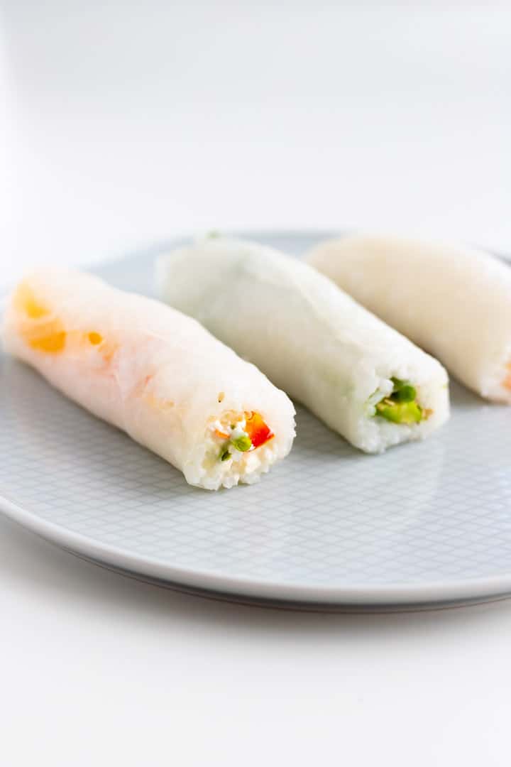 three homemade sushi rolls with vegetables and rice paper