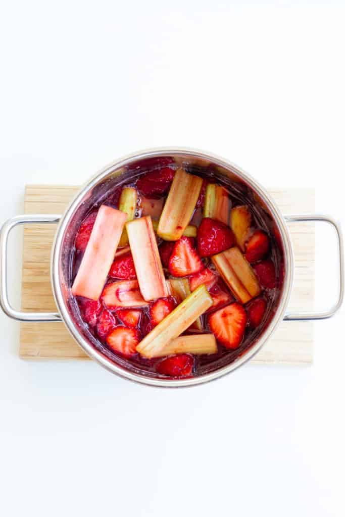 strawberry rhubarb jam cooking in a small saucepan