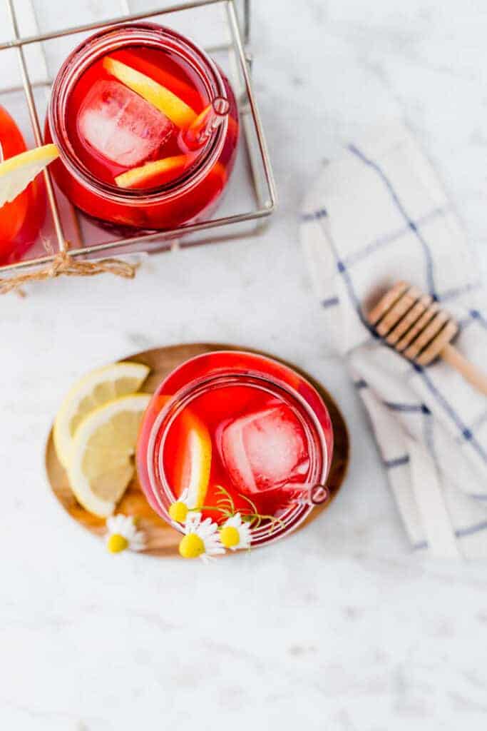 homemade iced tea served over ice with lemon and flowers