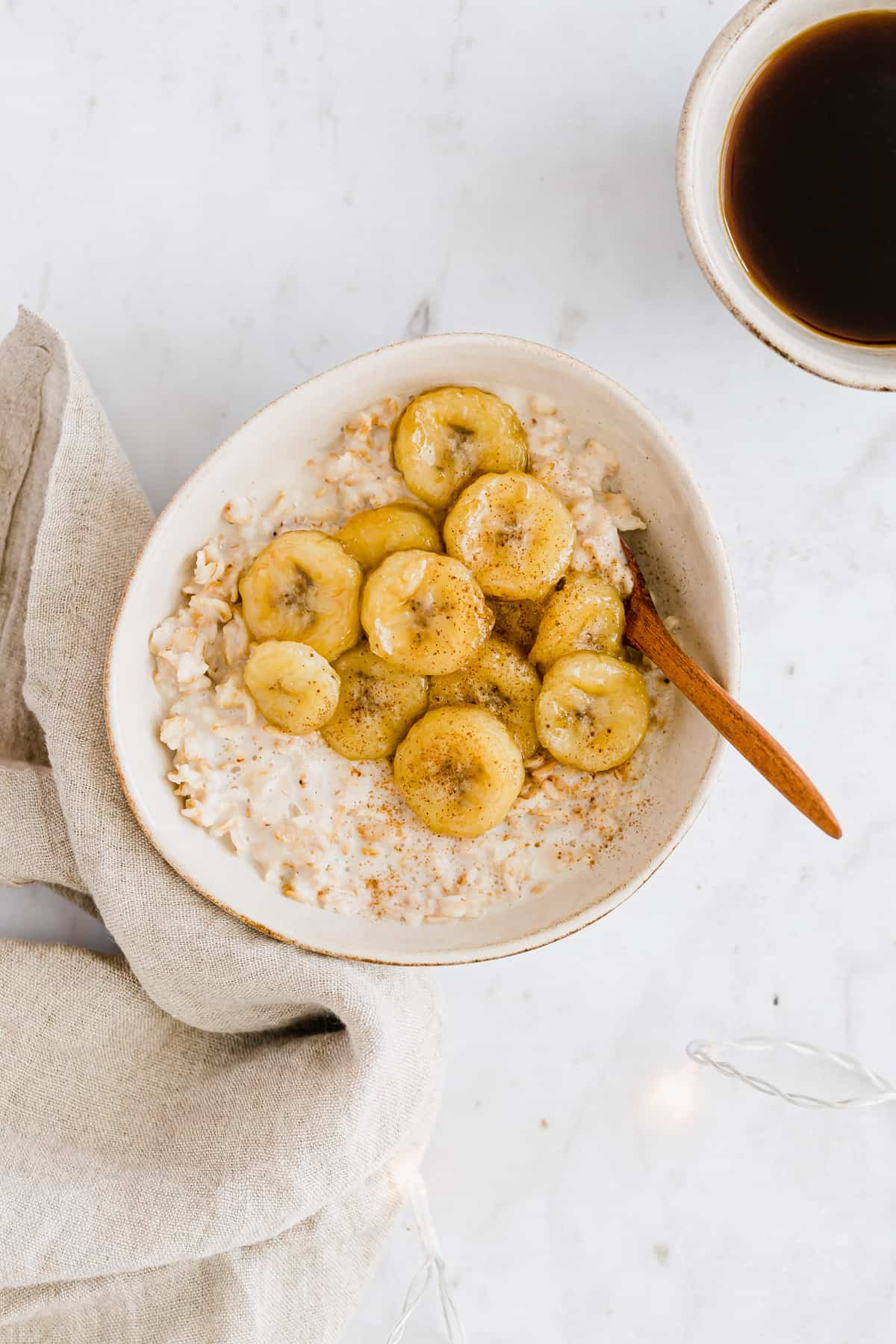 banana oatmeal next to a cup of coffee