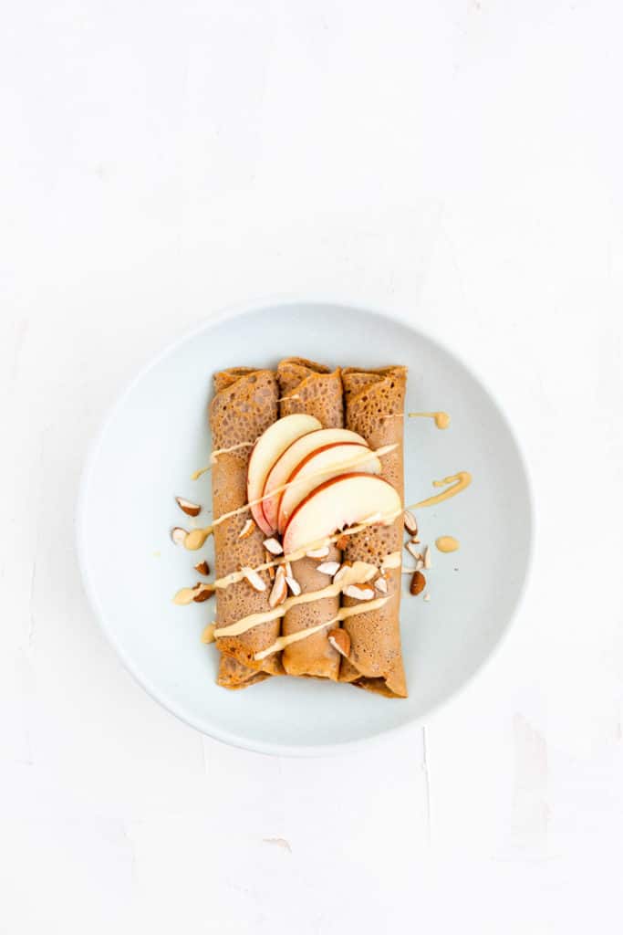 crepes topped with almond butter, nectarine wedges, and chopped almonds