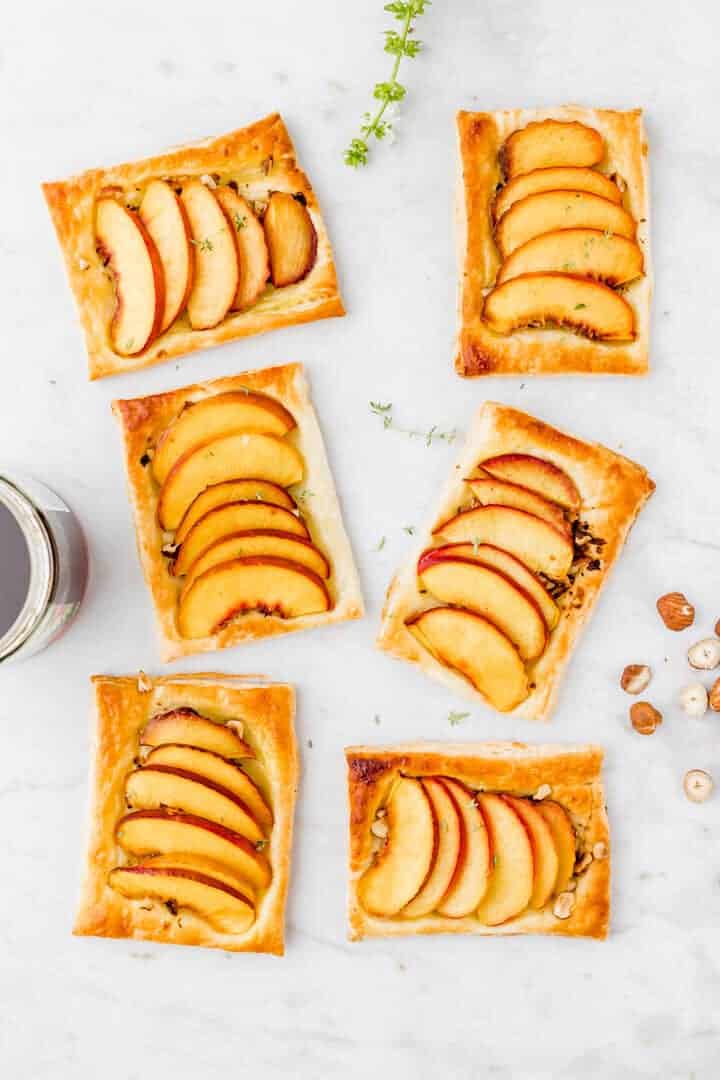 peach puff pastry tarts on a marble dish