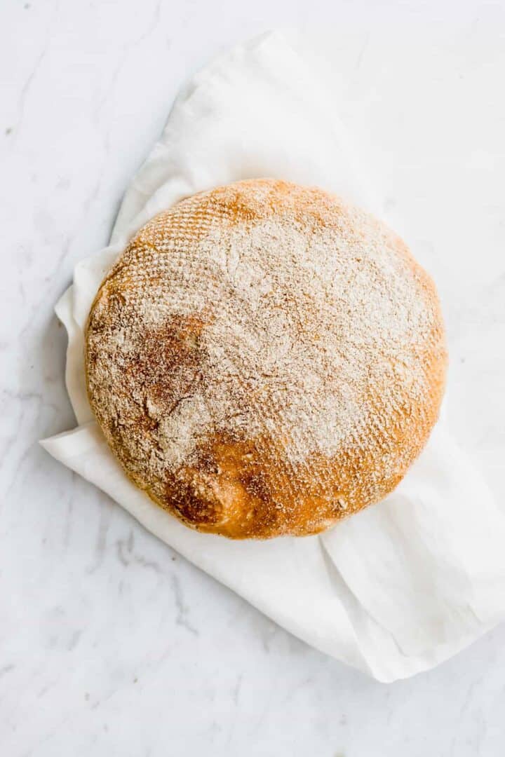 round no knead bread on a white linen napkin