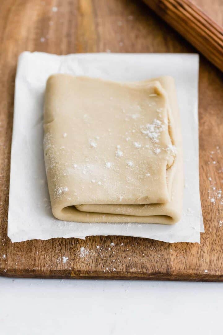 vegan rough puff pastry on a board next to a rolling pin
