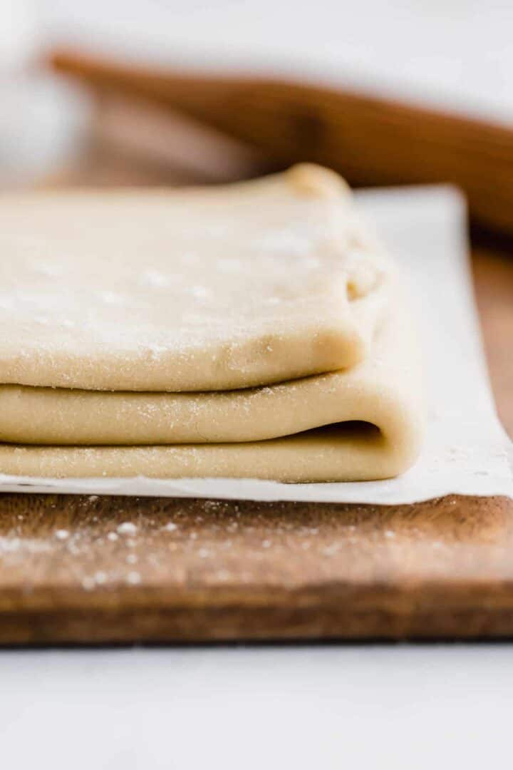 homemade rough puff pastry on a brown wooden board