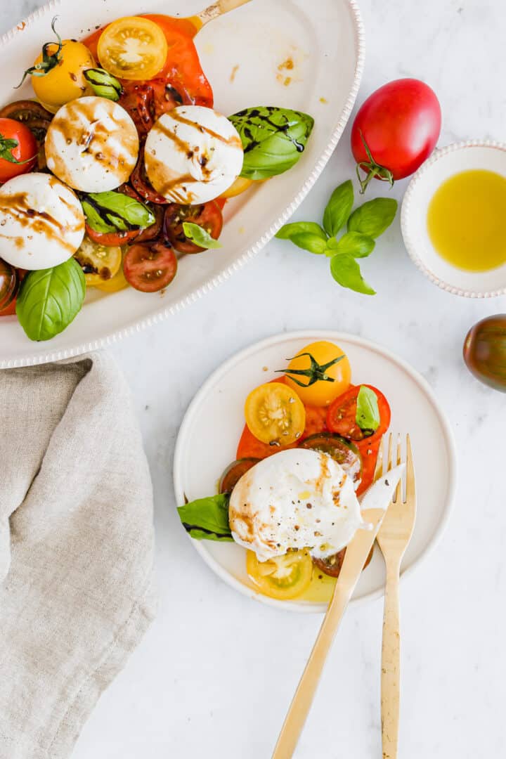 burrata salad with tomatoes served on plates