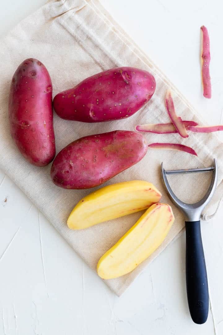 homemade potato soup, peeling red potatoes