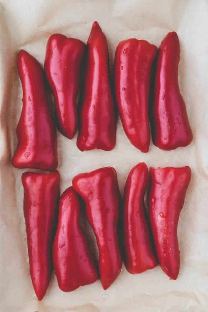 red peppers on a parchment paper ready to be roasted