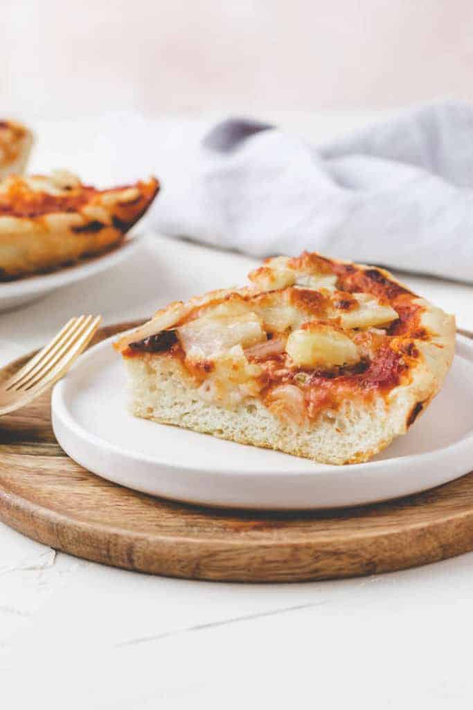 homemade pan pizza recipe served on a white plate