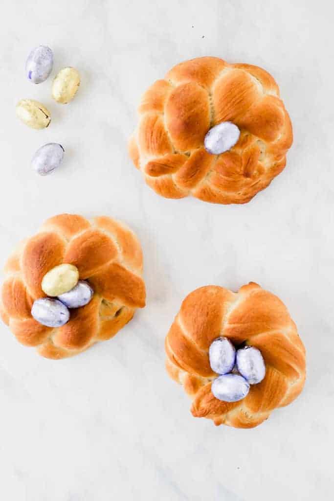 three vegan easter bread filled with chocolate eggs on a white background