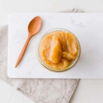 homemade unsweetened applesauce in a weck glass jar on a grey napkin