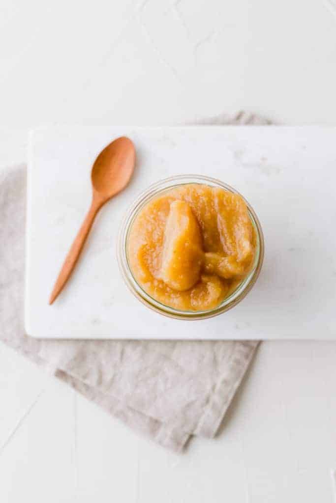 homemade unsweetened applesauce in a weck glass jar on a grey napkin