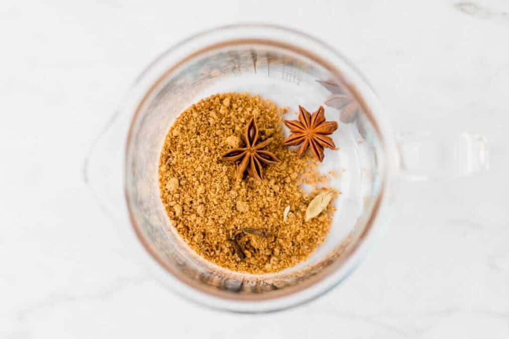 brown sugar, start anise, cardamom, and cloves in a glass bottle