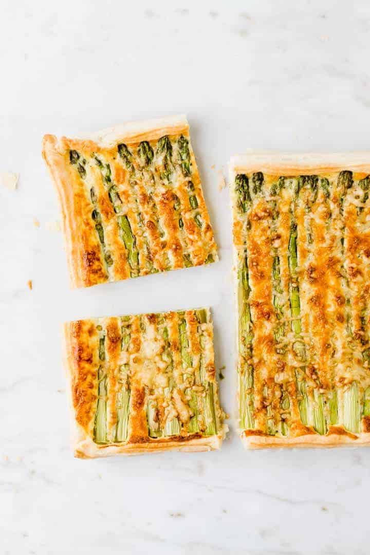 green asparagus and cheese tart on a white marble dish