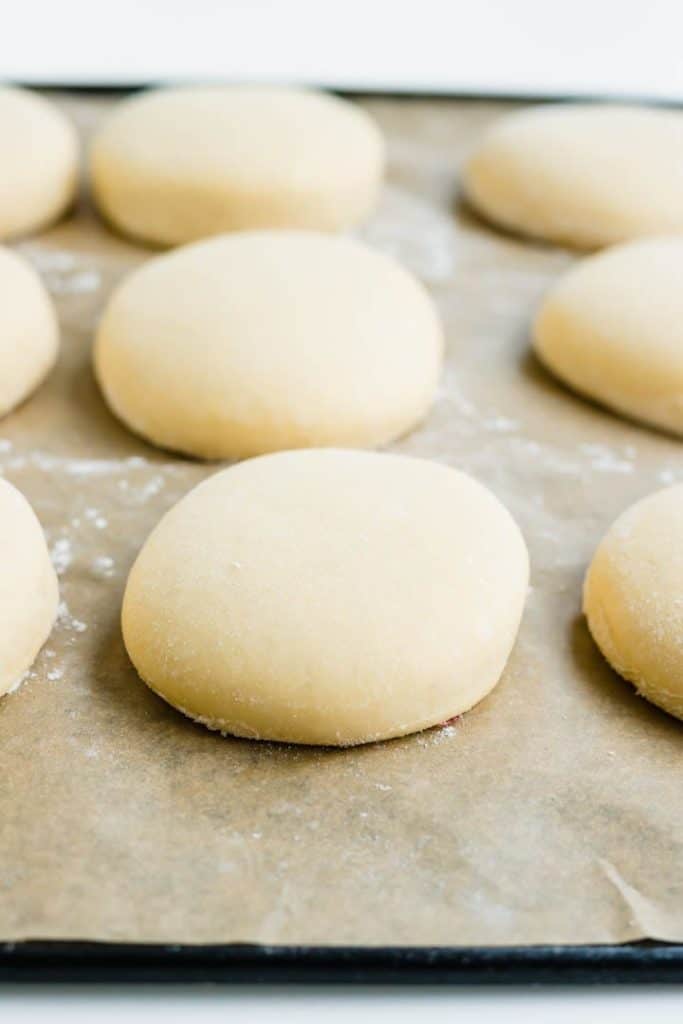 homemade donuts dough on a parchment paper before frying