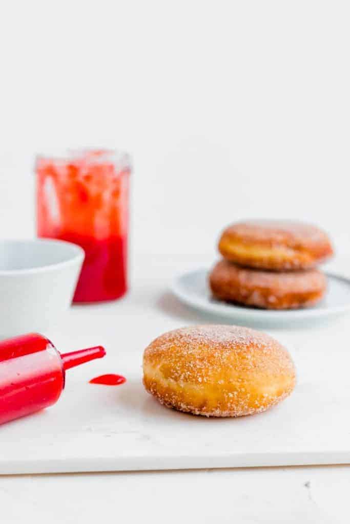 syringe pipe filled with jam to fill donuts