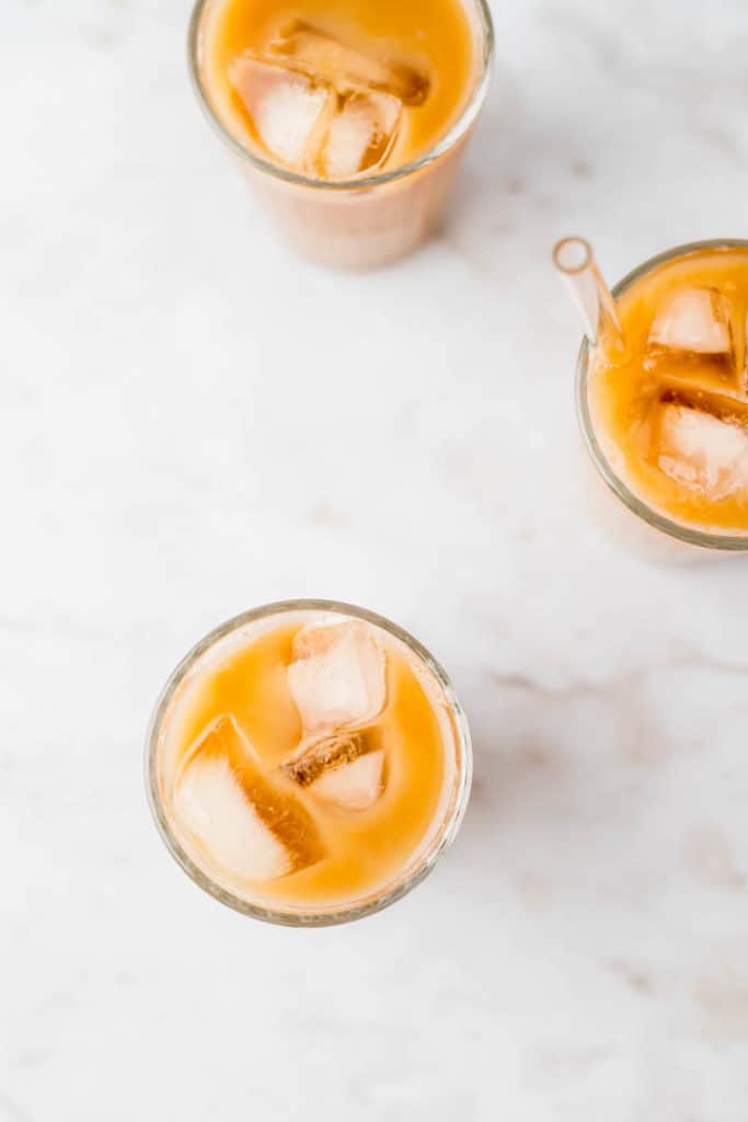 thai iced tea with ice cubes photographed from top