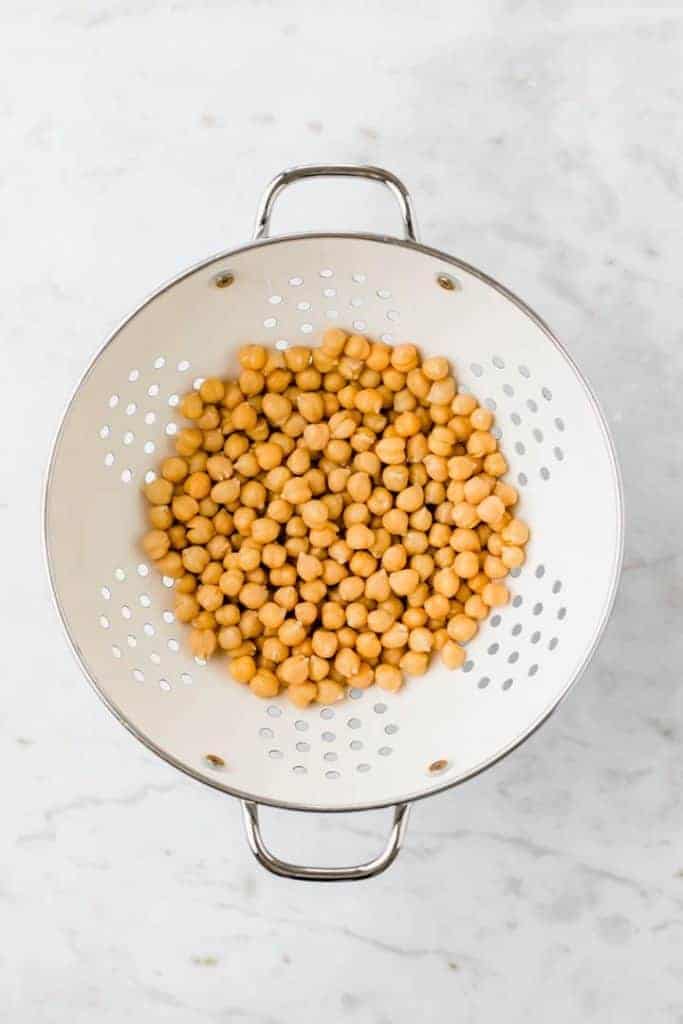 chickpeas in a white kitchen sieve