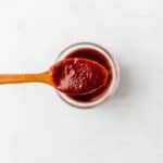 vegan bbq sauce on a wooden spoon