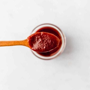 vegan bbq sauce on a wooden spoon