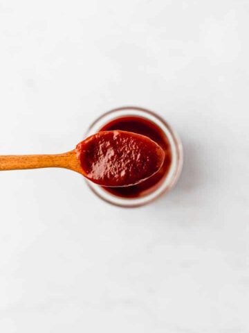 vegan bbq sauce on a wooden spoon