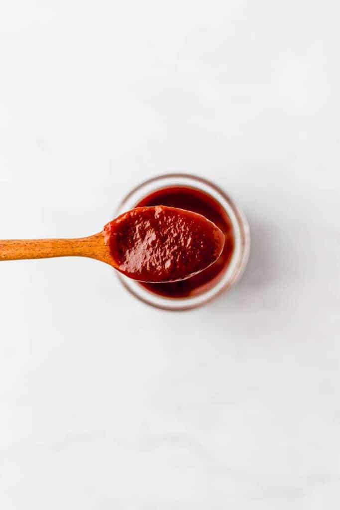 vegan bbq sauce on a wooden spoon