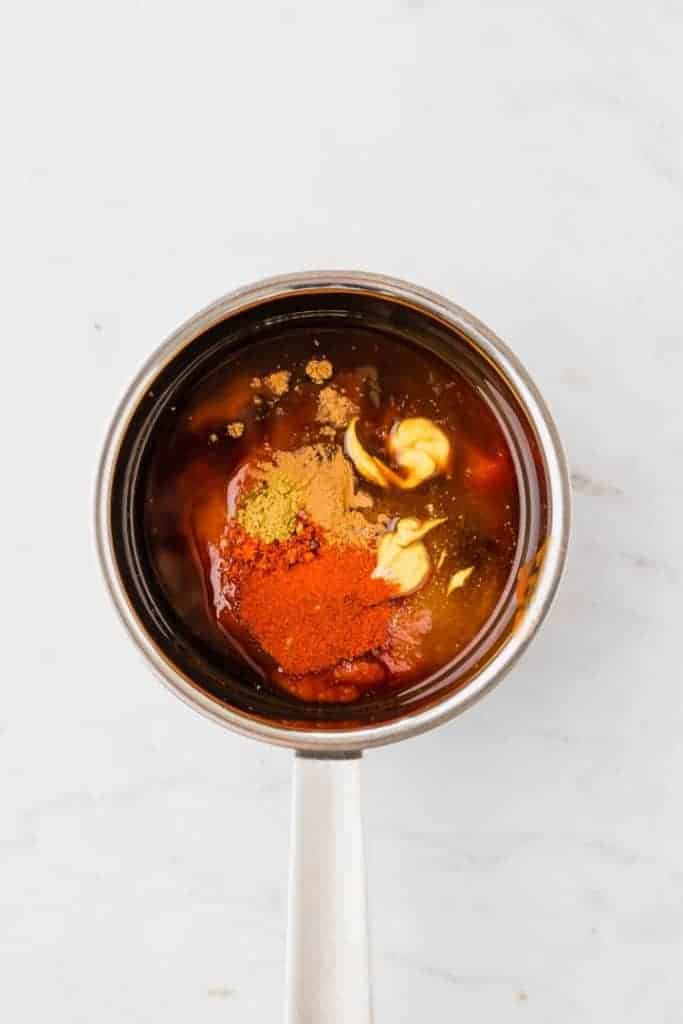bbq sauce ingredients in a small saucepan on a white table
