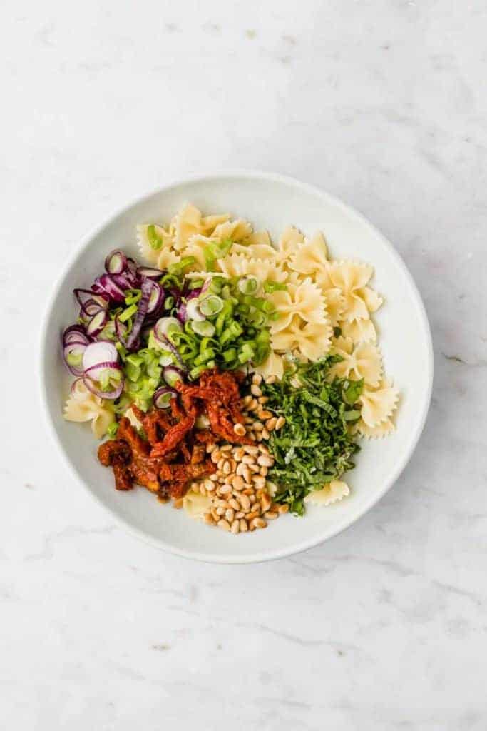 ingredients for pasta salad in a blue plate