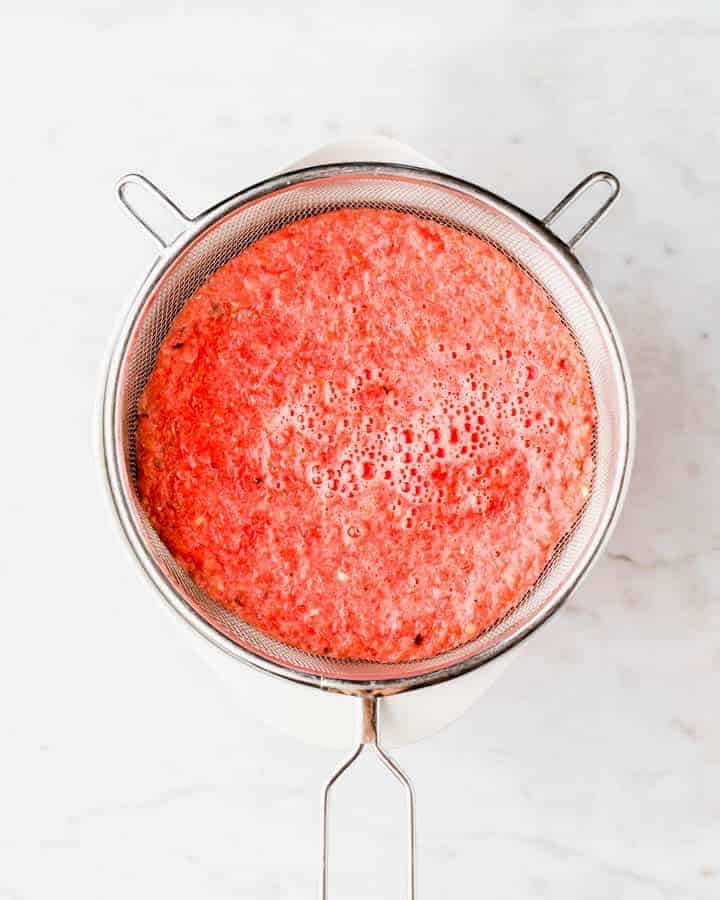 a sieve full with watermelon pulp