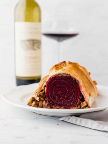 vegan beet wellington served with a bottle of red wine