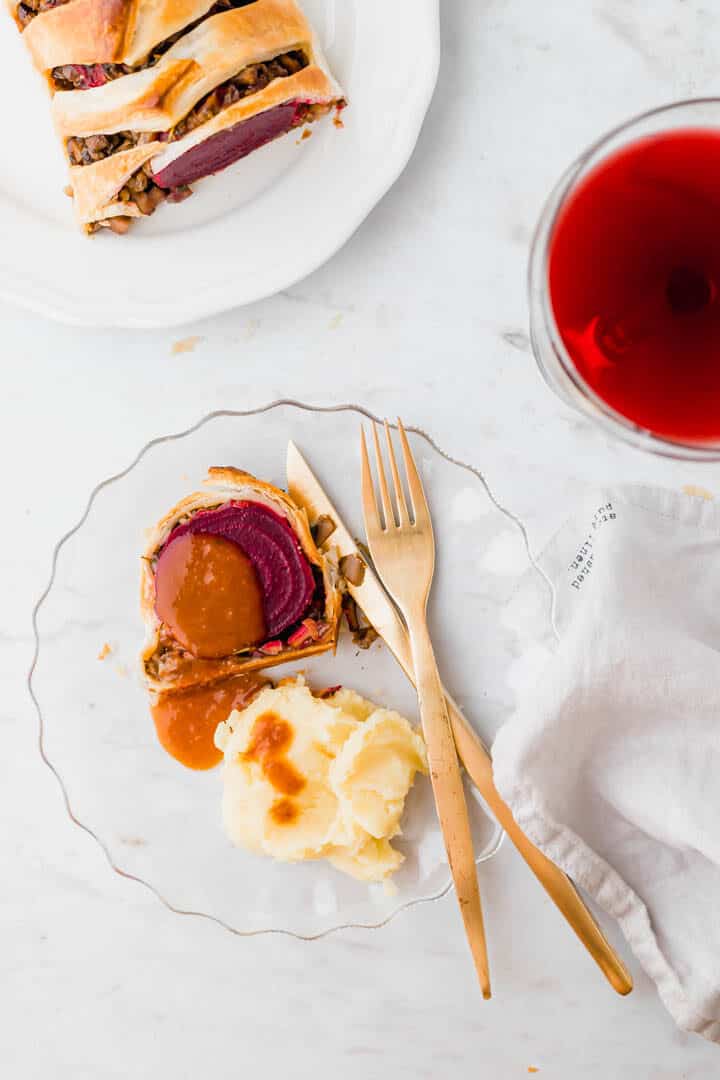 vegan wellington served with gravy, mashed potato, and wine