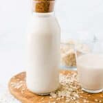 homemade oat milk in a glass bottle