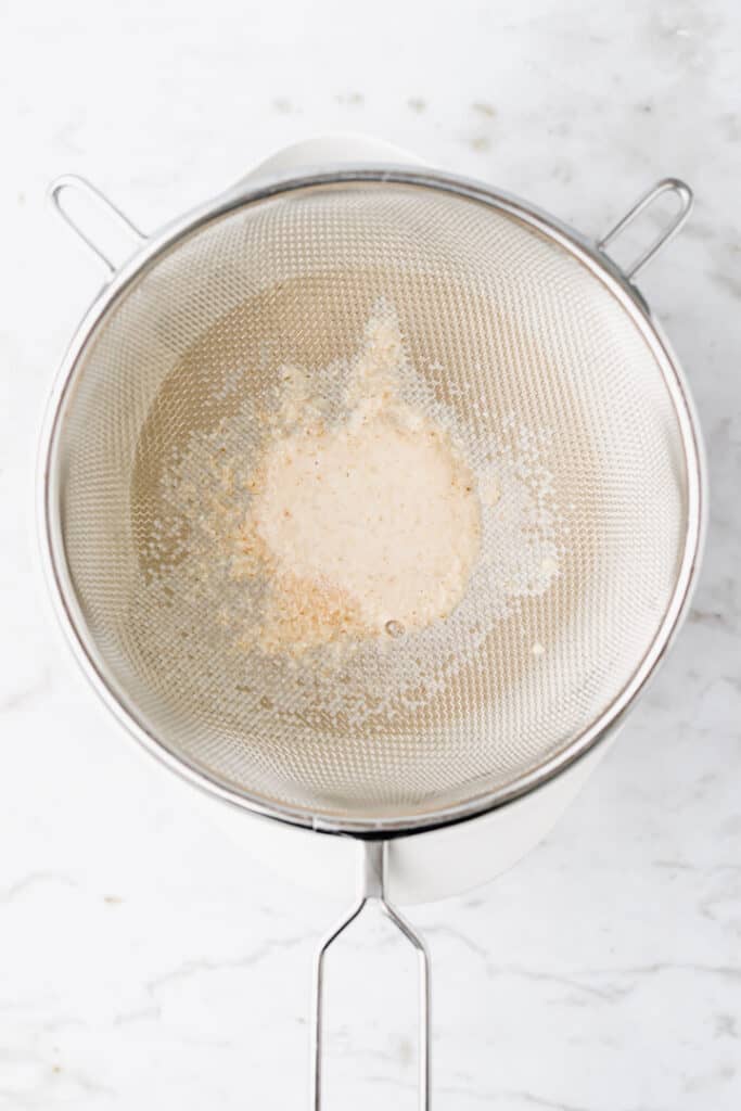 oat pulp leftovers in a sieve