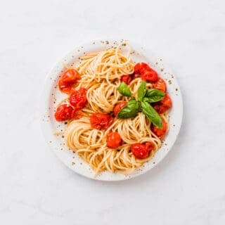 oven roasted cherry tomato pasta on a white plate