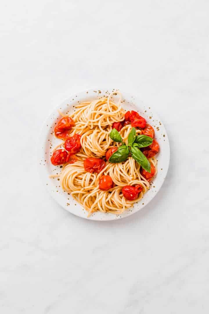 oven roasted cherry tomato pasta on a white plate