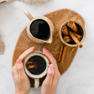 cafe de olla served in brown cups with cinnamon