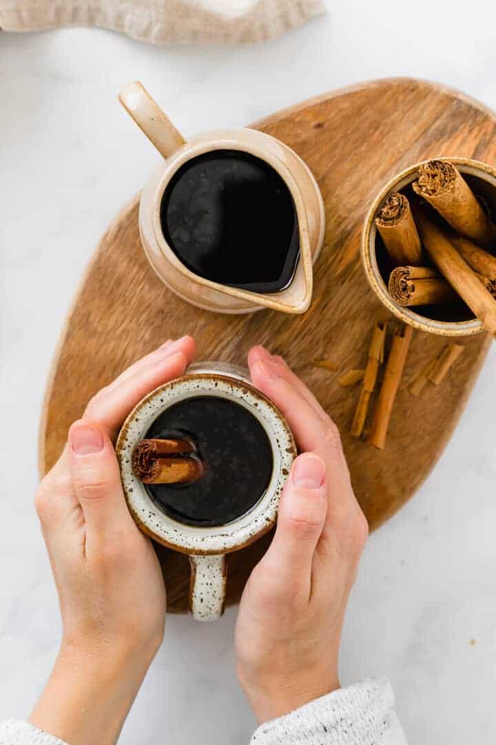 cafe de olla served in brown cups with cinnamon