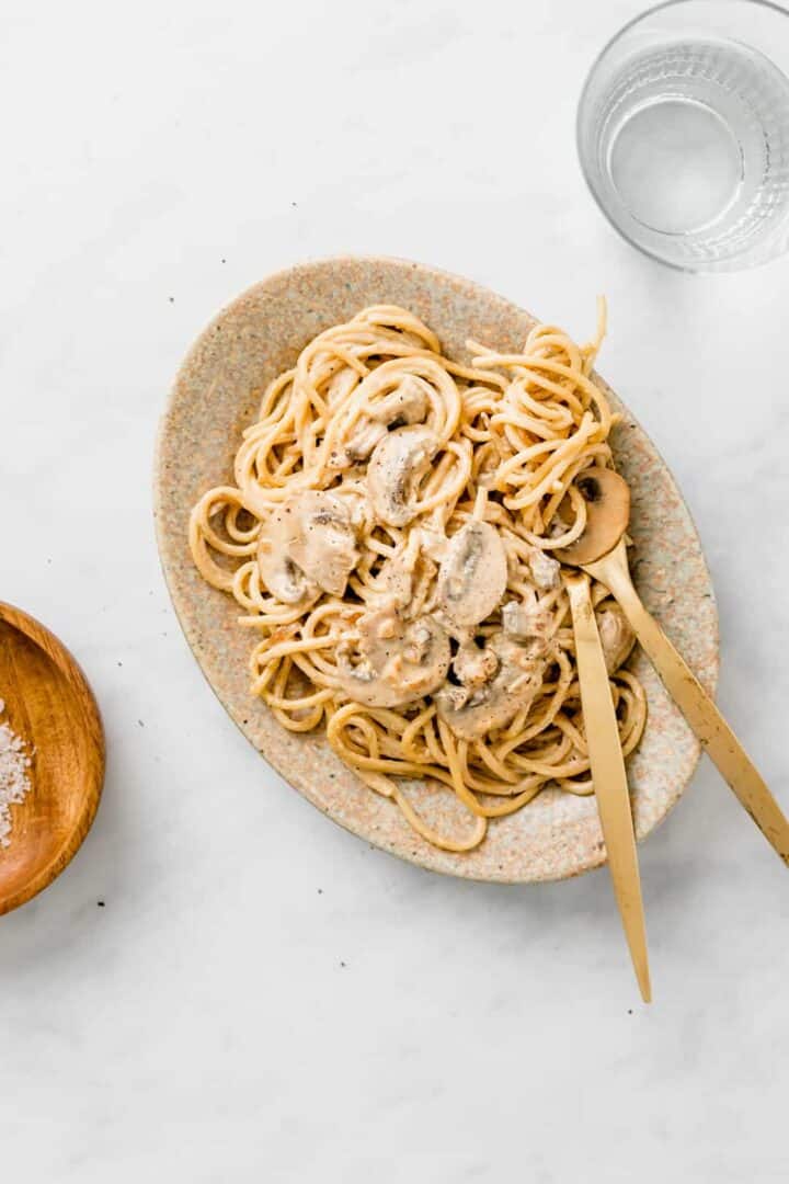 vegan pasta carbonara served on a brown plate