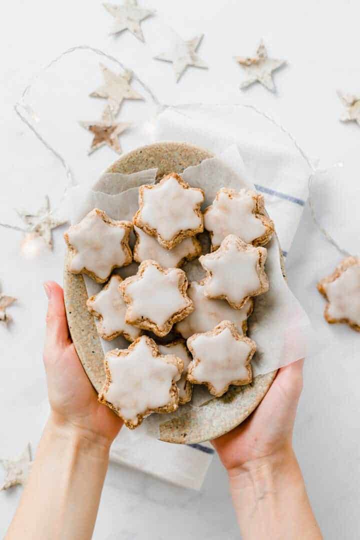 vegan cinnamon star cookies served on a brown plate