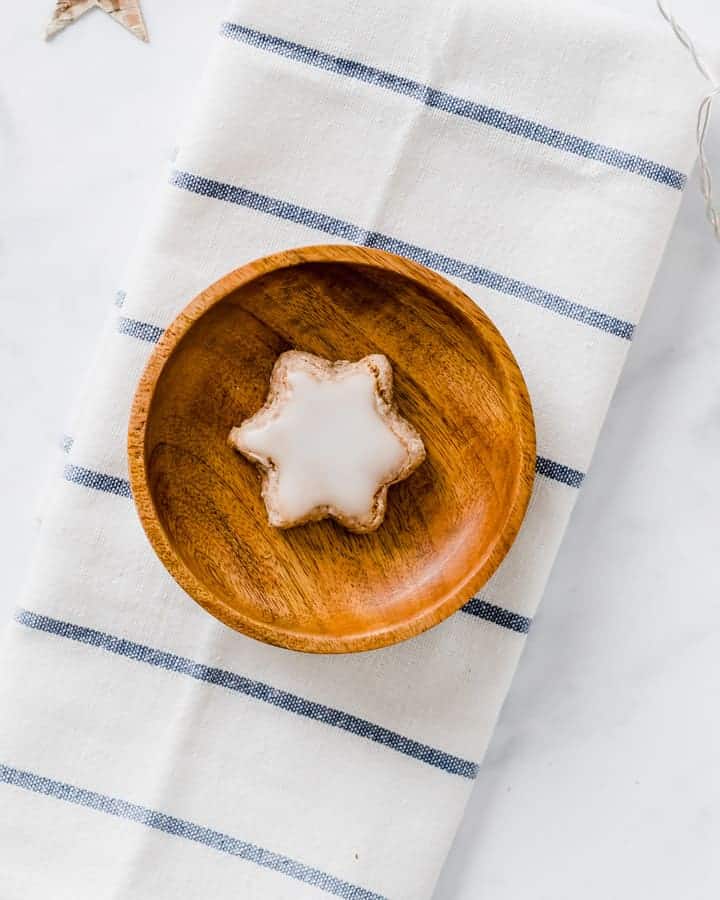 star cookie with powdered sugar glaze in a wooden bowl
