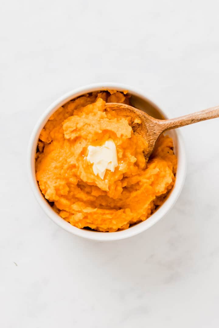 savory mashed sweet potatoes served with a piece of dairy-free margarine