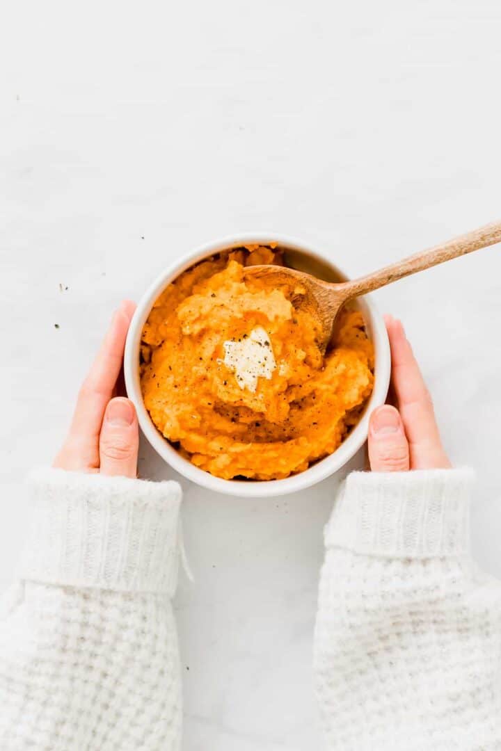two hands holding Vegan Mashed Sweet Potatoes