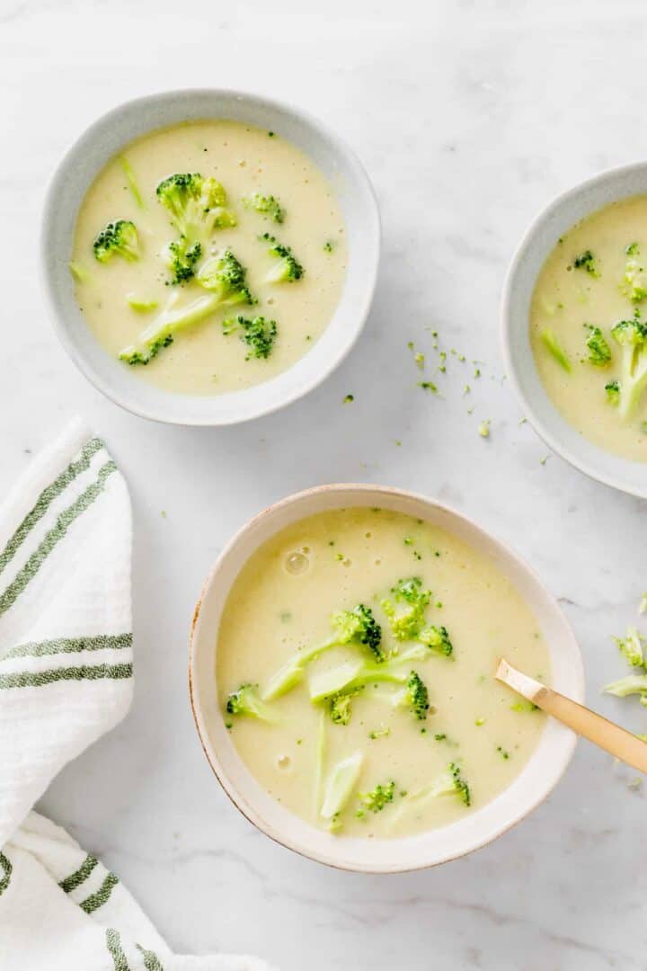 vegan broccoli soup served in blue bowls