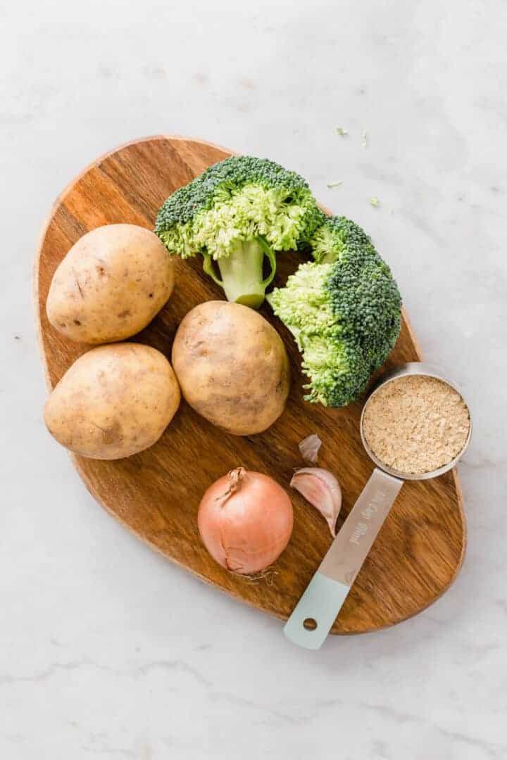 ingredients for broccoli potato soup on a wooden board